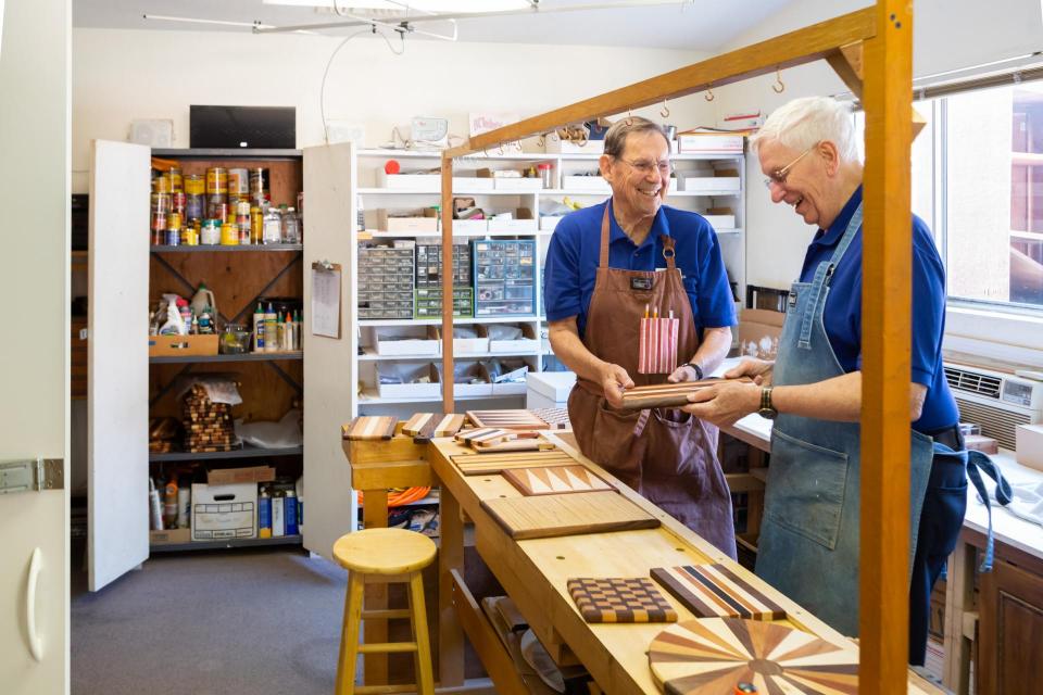 Two male residents working in community woodwork shop