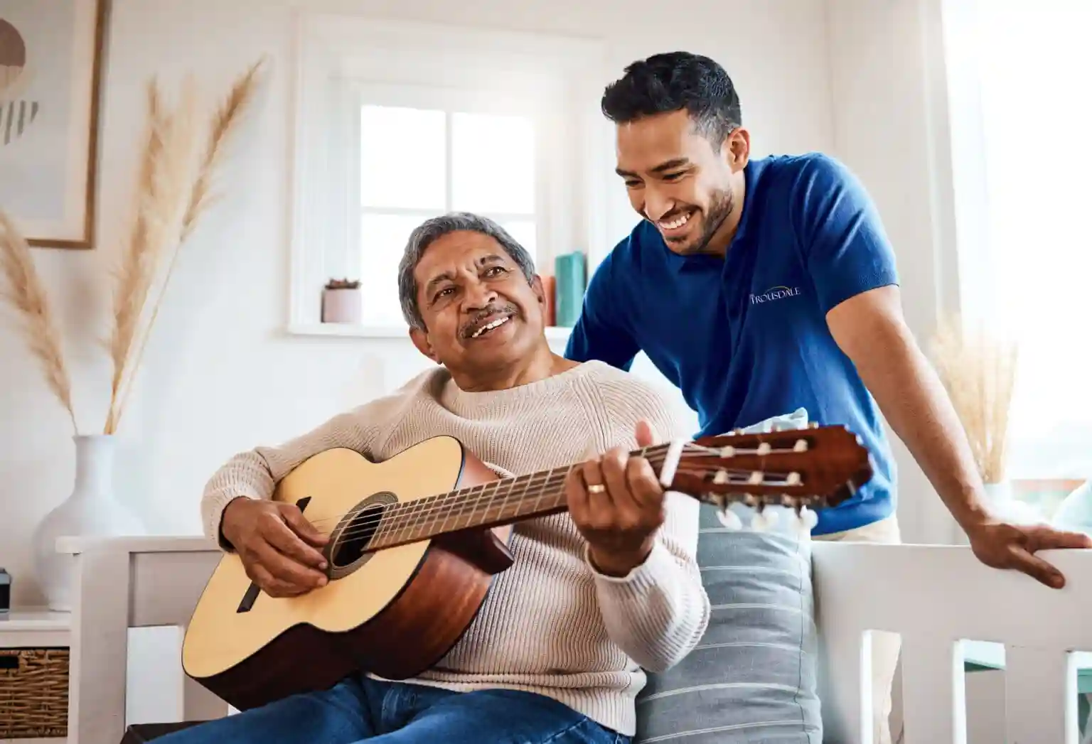 Staff and resident with guitar 1536x1047
